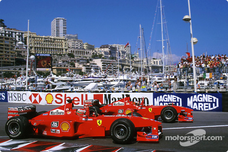 Race winner Michael Schumacher celebrates with second place Eddie Irvine