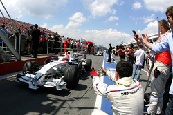 Race winner Robert Kubica celebrates