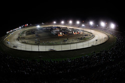 Cars race through turns three and four