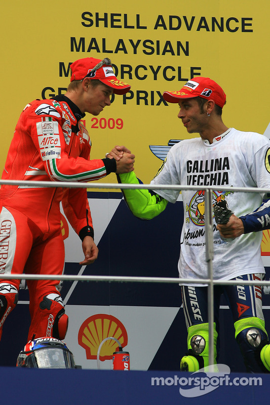 Podium: race winner Casey Stoner, Ducati Marlboro Team with third place and 2009 MotoGP champion Val